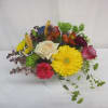 This centerpiece arrangement is an abundance of blooms and colors, sure to