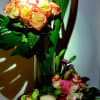 This beautiful creation has a dozen roses, standing tall in a glass