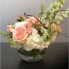 Blush pink roses and spray roses set among hydrangea and larkspur with