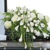 Elegant white premium flowers in a lush casket spray.

The Elegant Love Casket