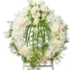 A combination of cream and white blooms in this wreath makes a