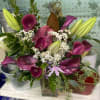 This vase arrangement is made up of lilies, peace lilies, and calla