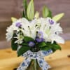 This thoughtful arrangement is beautiful and makes a statement of Peace. For