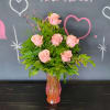 This gorgeous arrangement offers six pink roses surrounded by a mix a