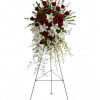 Pure white lilies and dendrobium orchids mingle with red roses, white asiatic