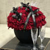 In a black vase, a symphony of passion unfolds. Seventy-five red 