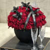 In a black vase, a symphony of passion unfolds. Seventy-five red 