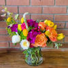 Sunset Serenade- a beautiful arrangement with orange free spirit roses, tulips, garden