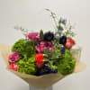 hand tie wrapped bouquet displayed in a vase