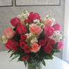 Light Pink and Dark Pink Roses come beautifully arranged in a glass