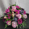 Delightful mixture of roses, carnations, daisies, and berries arranged in a 4x4