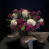 Tranquil whites roses, hot pink and soft pink carnations that mingle together
