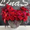 A bouquet of red roses paired with pink spray roses creates a