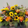 Woodland Inspired Basket with Sunflowers, Vibrant Roses and a combination of branches
