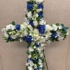 A cross filled with fresh cut flowers.