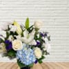 A white and blue vase arrangement featuring big and small blooms!