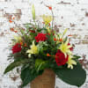 An elegant combination of soft Yellow Lilies, Red Roses, complimentary flowers and