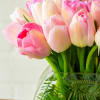 The beautiful arrangement showcases 50 tulips gathered in a modern vase, creating