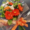 Honor a Hiller with these special curated wrapped blooms consisting of orange