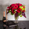 The floral arrangement in the tall crystal vase is truly exquisite. It
