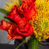 Experience a burst of color with this vibrant arrangement featuring bright orange