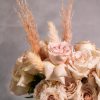 The sand color roses are elegantly displayed in a modern 6-inch tall