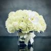 This arrangement has over 36 Blooms of pale green white Roses accented