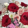 Nestled within this chic handbag are enchanting flowers bursting with color and