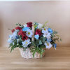 This arrangement features a patriotic display of blue, red and white florals.