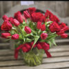 This classic arrangement features 2 dozen red rose stems and 50 red