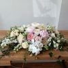 Beautiful white, pink and blush flowers sweetheart table centerpiece