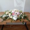 Beautiful white, pink and blush flowers sweetheart table centerpiece
