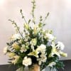 Soothing and calming, this peaceful arrangement of white assorted flowers is nestled