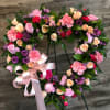 Send your sympathy with our precious heart easel filled with assorted flowers