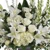 A traditional mix of all white flowers and assorted greenery designed in