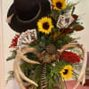 Flowers with cowboy hat and poker hand of cards.
