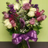 Want a delightful arrangement? Send this gorgeous purple floral bouquet that is
