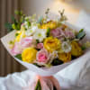 A delightful bouquet featuring a charming mix of yellow and white roses