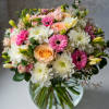 A charming and beautiful bouquet in a clear vase, featuring a delightful