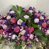 This vivid and tropical casket spray evokes the feelings of paradise for