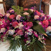 This vivid and tropical casket spray evokes the feelings of paradise for