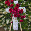 A white cross with a red rose sash. This Cross comes ready
