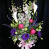 An amazing full flower arrangement with a gorgeous bow and quality vase
