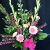 Winter /spring mixed bouquet of seasonal flowers and gerber daisies.  Shown