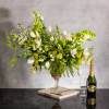 The beautiful arrangement features long white tulips, snapdragons, boulevard beautiful umbrella ferns