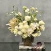 This arrangement is made with a designer&#039;s choice array of seasonal white