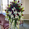 A beautiful arrangement of red roses, white oriental lilies, and white orchids.