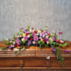 This beautiful spray is created with luxurious flowers in bright and comforting