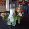 Simple and sophisticated replica of vintage bottles budvases filled with single flower