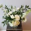 Elegant, soft, and full arrangement featuring larkspur, freesia, lisianthus, and other seasonal